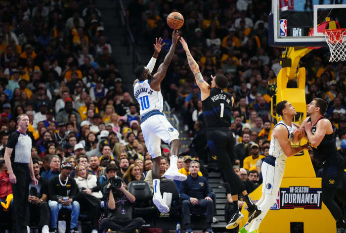Mavs' Tim Hardaway Jr. shoots a fadeaway jumper over Nuggets' Michael Porter Jr.